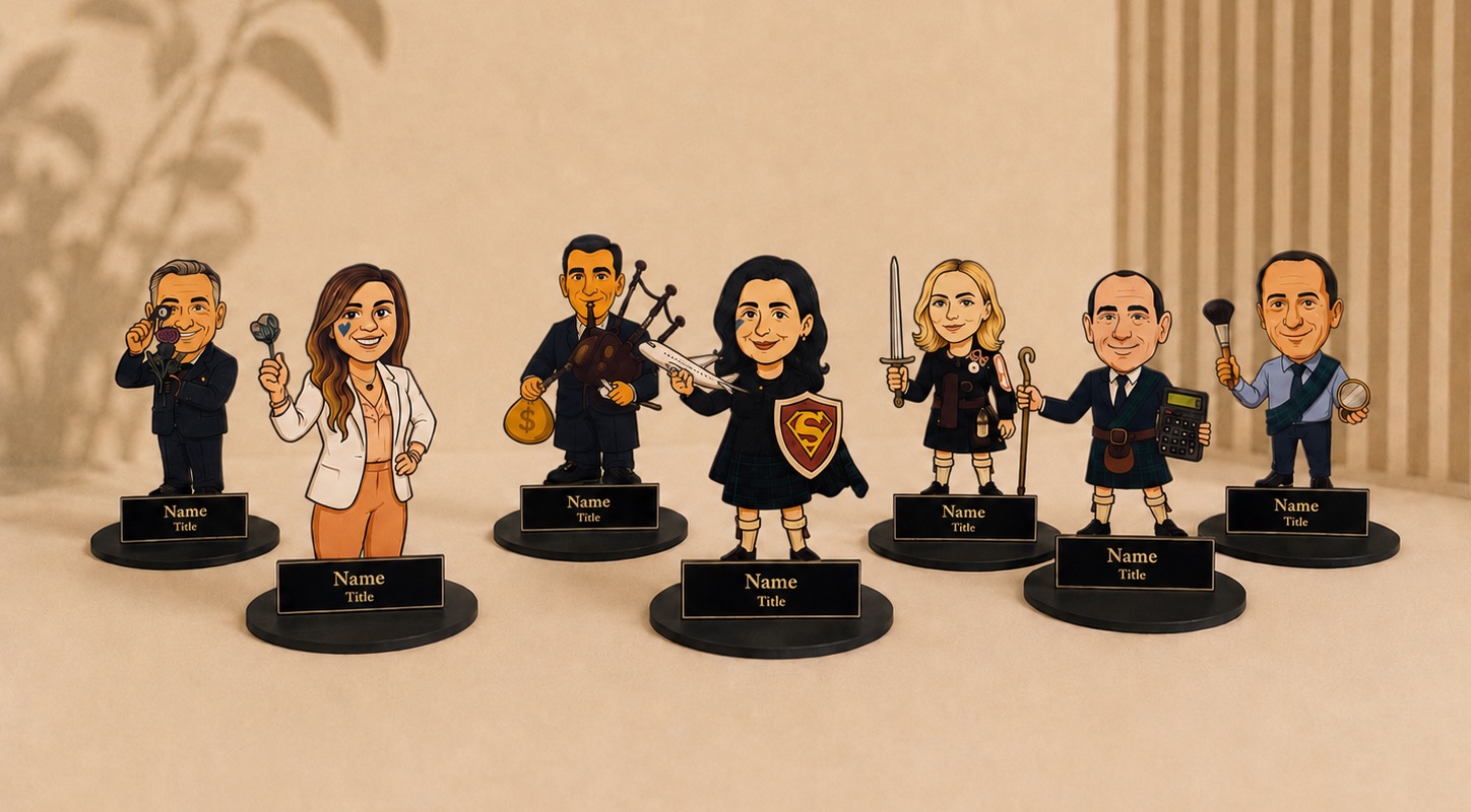 Seven 2.5D pieces in a row, each a caricature of a team member holding
                  something they are known for, every one on its own base with a nameplate